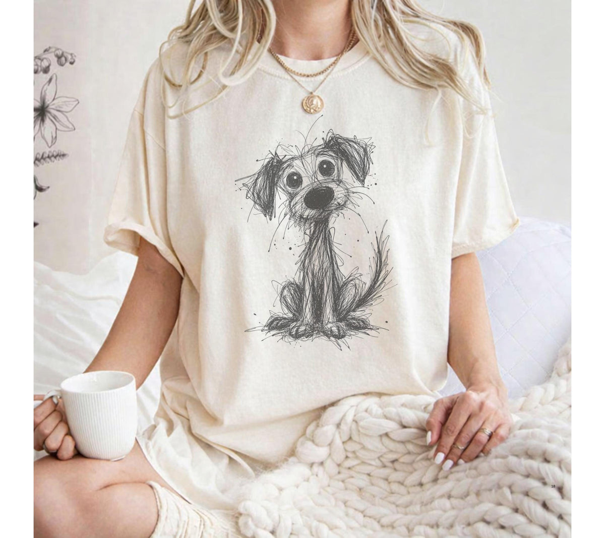 Ivory T-shirt with a wide-eyed puppy drawn in scribbled black lines