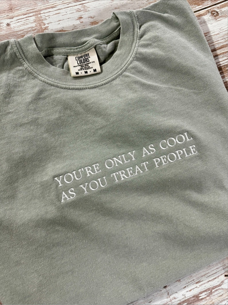 Sandstone T-shirt with white You’re Only as Cool as You Treat People lettering