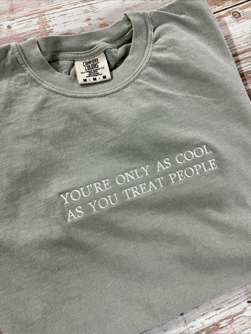 Sandstone T-shirt with white You’re Only as Cool as You Treat People lettering