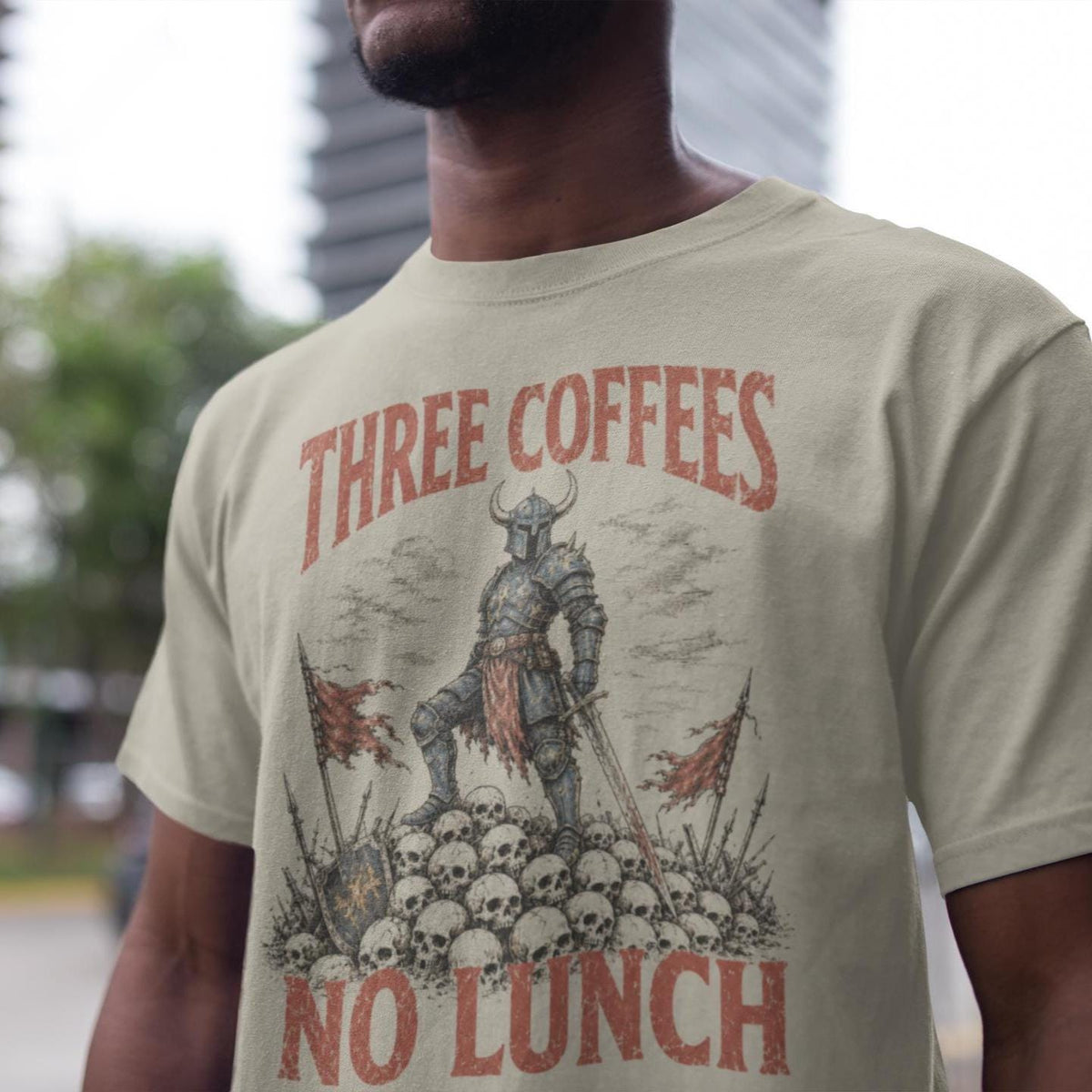 Sand T-shirt with an armored warrior, skulls and Three Coffees No Lunch lettering
