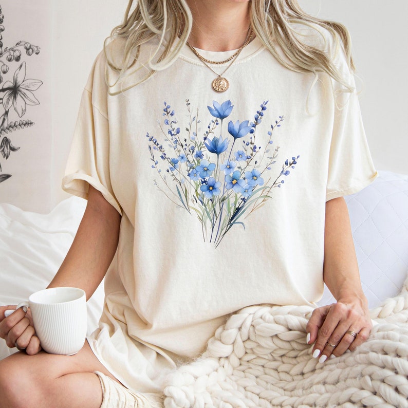 Ivory T-shirt with a blue watercolor-style flower bouquet