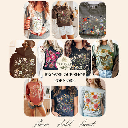 May include: A collage of various apparel items featuring floral designs. The items include a mug, sweatshirts, hoodies, and t-shirts in various colors. The text "Browse our shop for more" is visible, along with the words "Flower field forest".