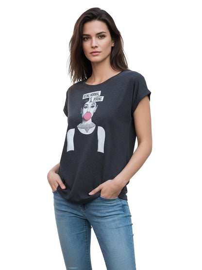 May include: Dark gray t-shirt with a graphic of a woman blowing a bubble gum bubble, wearing a pearl necklace. The text "BEING NORMAL IS BORING" is above the graphic. The model is wearing blue jeans.