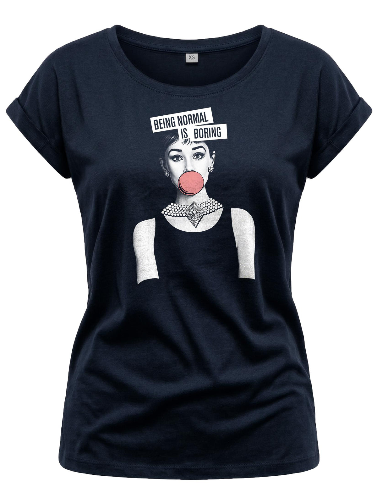 May include: Navy blue t-shirt featuring a graphic of a woman blowing a bubblegum bubble, with the text "BEING NORMAL IS BORING" above her head. The woman is wearing a necklace and earrings. The shirt has rolled-up sleeves.