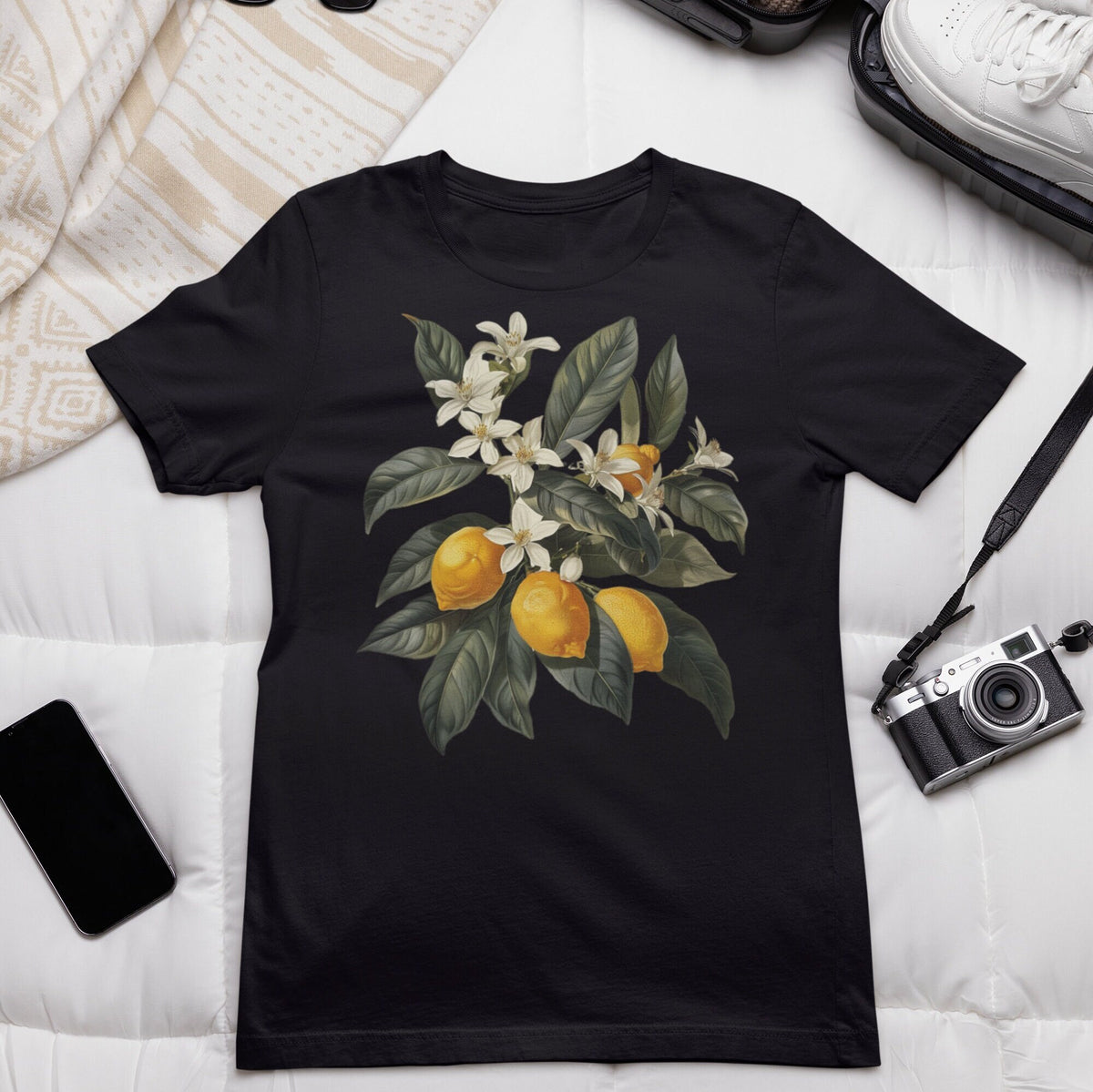May include: Black t-shirt with a vintage illustration of a lemon tree branch with white blossoms and yellow lemons.