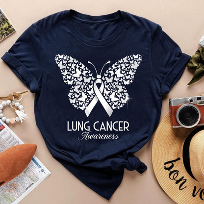 May include: Navy blue t-shirt featuring a white butterfly design composed of smaller butterflies, with a white ribbon in the center. The text "LUNG CANCER Awareness" is printed below the butterfly. The shirt is a classic crew neck.