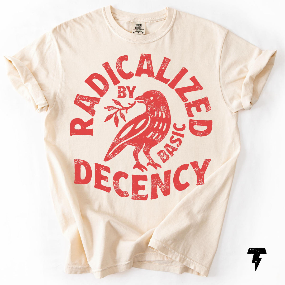 May include: Cream-colored t-shirt with rolled-up sleeves. The front features a distressed red graphic of a bird holding a sprig, encircled by the words "RADICALIZED BY BASIC DECENCY."