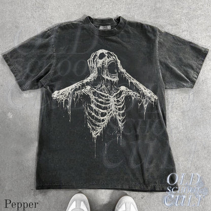 May include: Dark grey t-shirt featuring a distressed white skeleton graphic with an open mouth and outstretched arms. The shirt has a crew neck and short sleeves. The text "OLD SCHOOL CULT" is visible on the bottom right.