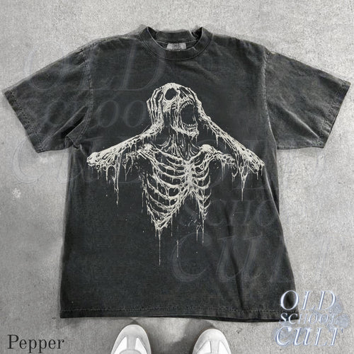 May include: Dark grey t-shirt featuring a distressed white skeleton graphic with an open mouth and outstretched arms. The shirt has a crew neck and short sleeves. The text "OLD SCHOOL CULT" is visible on the bottom right.