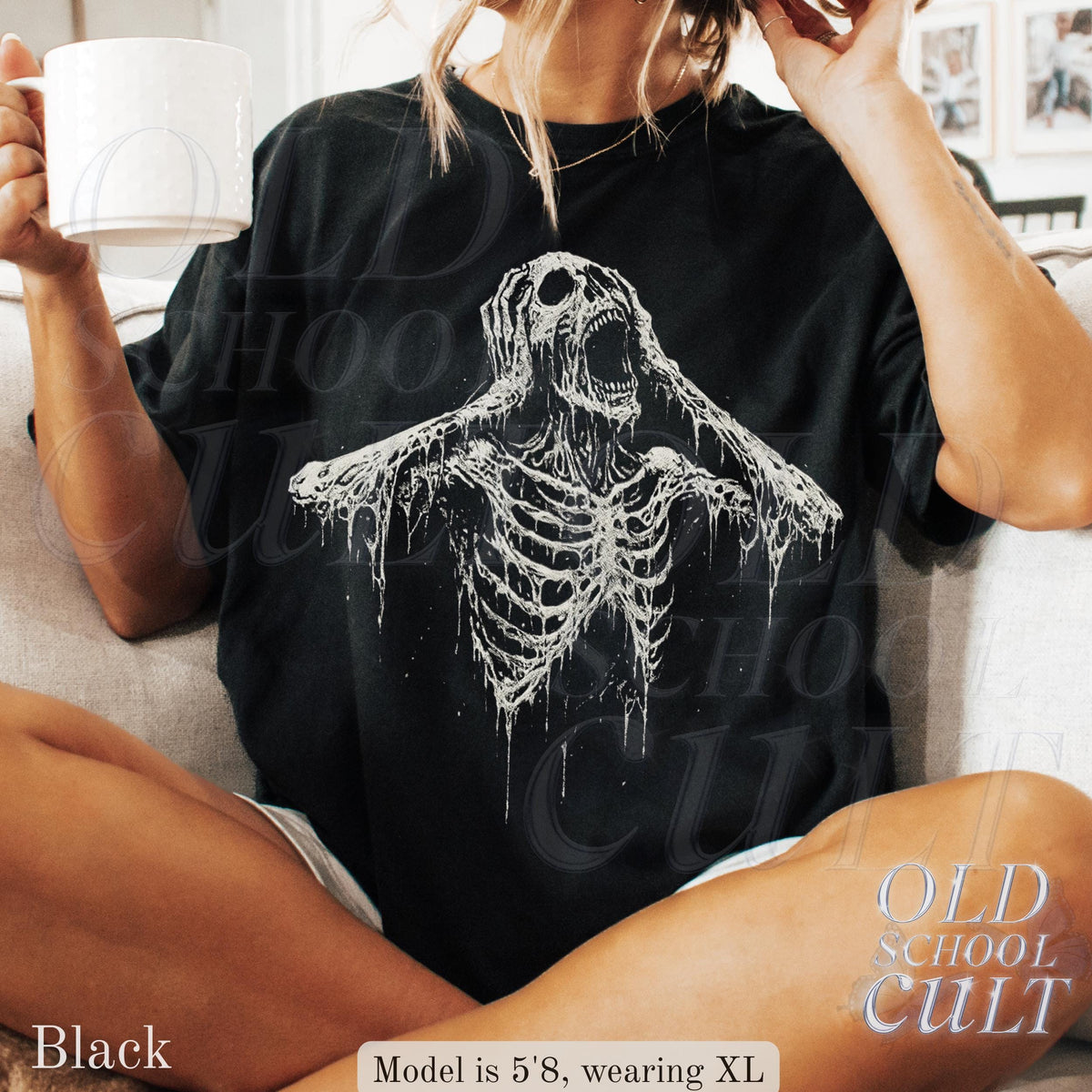 May include: Black t-shirt featuring a white graphic of a screaming skeleton. The shirt has the text "OLD SCHOOL CULT" printed on the lower right side. The model is wearing an XL size.