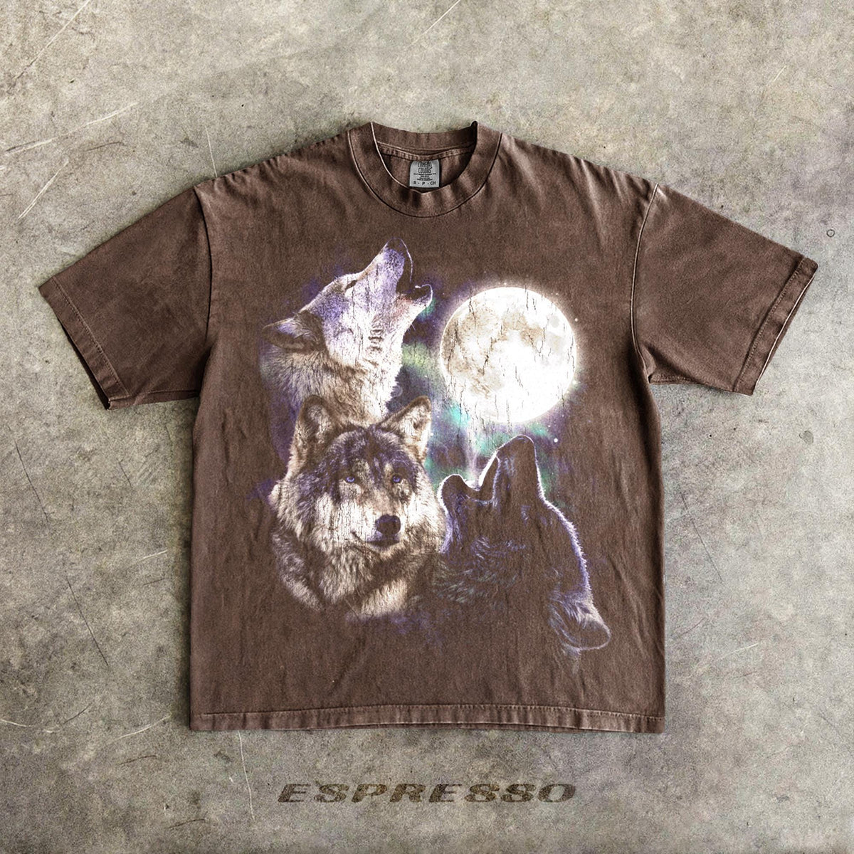 May include: Espresso-colored t-shirt featuring a graphic of three wolves howling at a full moon. The design includes shades of purple and white, with the word "ESPRESSO" printed at the bottom.
