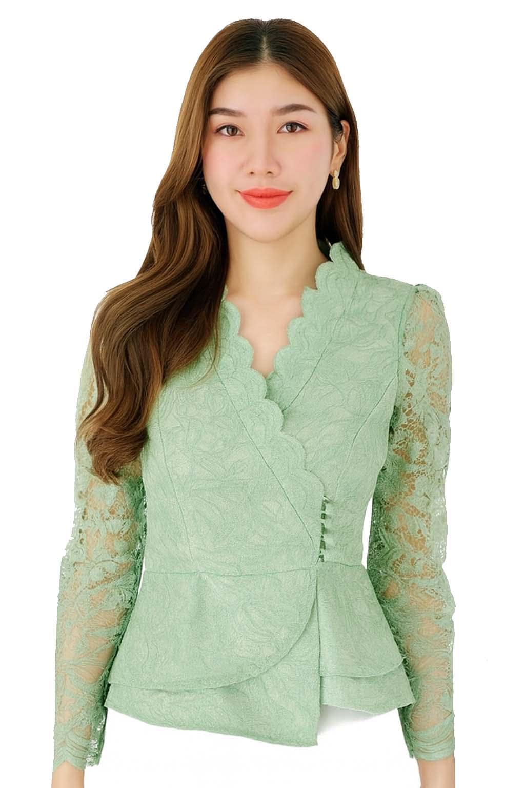 May include: A light green lace blouse with a scalloped neckline and long sleeves. The blouse has a wrap-style design with a peplum hem and button details. The intricate lace pattern adds a delicate touch to the garment.