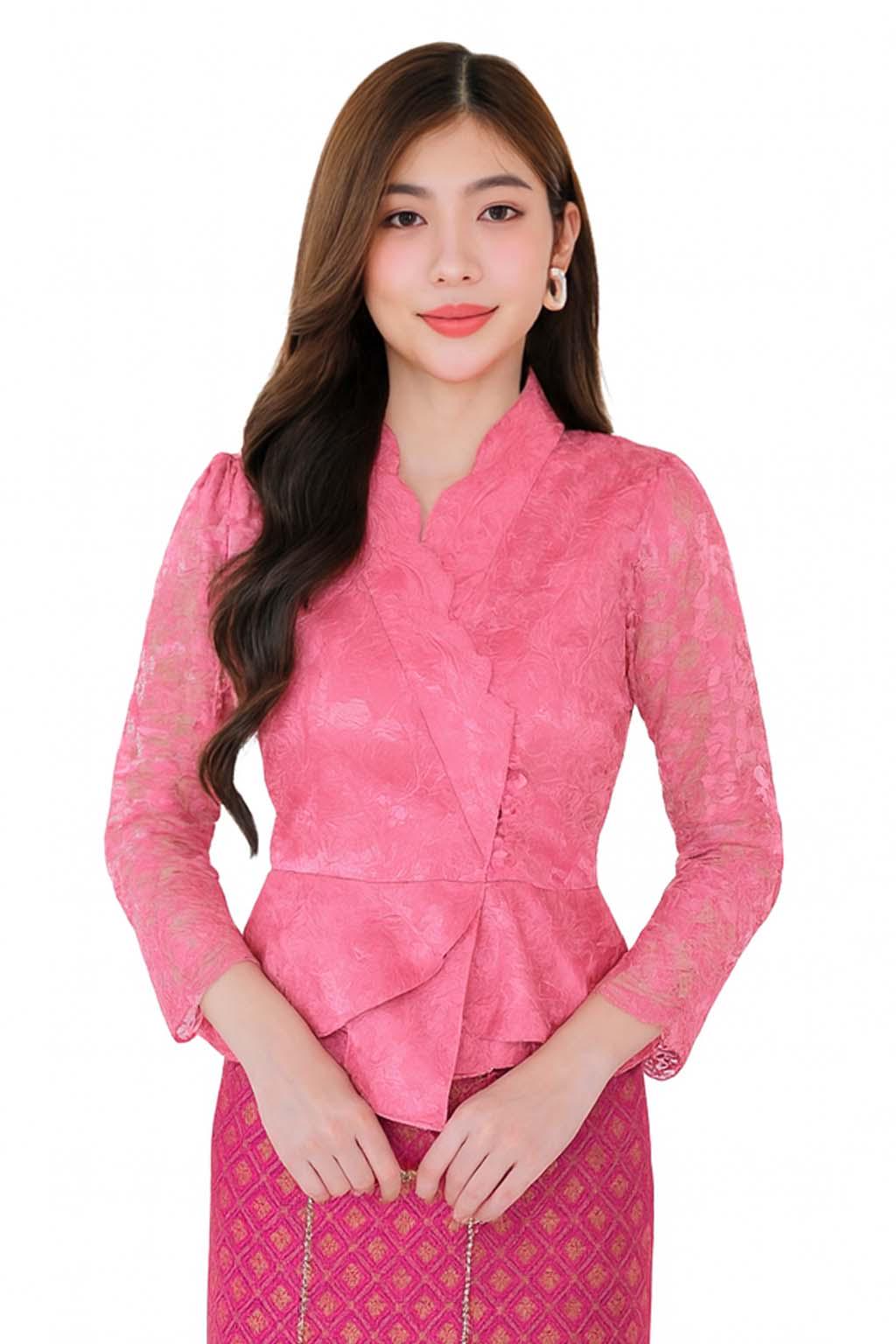 May include: A pink lace blouse with long sleeves and a wrap-style design. The blouse has a high collar and a peplum waist. The model is wearing a matching pink skirt with a gold pattern.