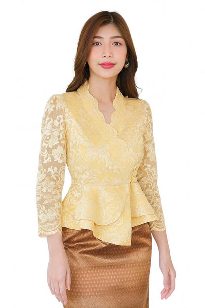 May include: A yellow lace blouse with a wrap-style design and three-quarter sleeves. The blouse has a peplum detail at the waist and is paired with a brown patterned skirt. The outfit is suitable for formal occasions.