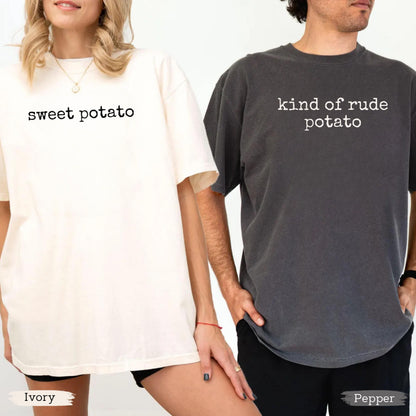 May include: Two oversized t-shirts, one ivory and one pepper-colored. The ivory shirt has the words "sweet potato" printed in black. The pepper-colored shirt has the words "kind of rude potato" printed in white. Both shirts have short sleeves.