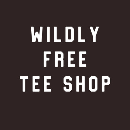 May include: A dark brown background with the words "WILDLY FREE TEE SHOP" in bold, white, uppercase letters. The text is arranged in three lines, with each word centered.