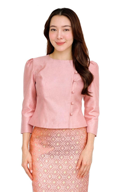 May include: A light pink blouse with three-quarter sleeves and a round neckline. The blouse features a button closure on the side and is paired with a patterned skirt. The outfit is a traditional style, suitable for formal occasions.