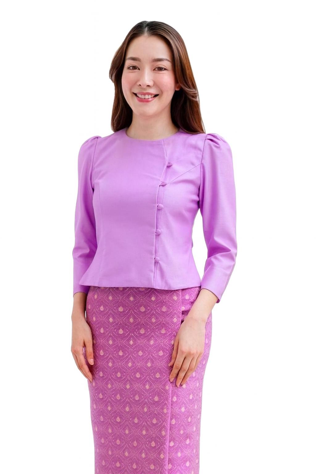 May include: A lilac-colored blouse with three-quarter sleeves and a matching skirt. The blouse features a buttoned front and a round neckline. The skirt has a repeating geometric pattern in shades of pink and purple.