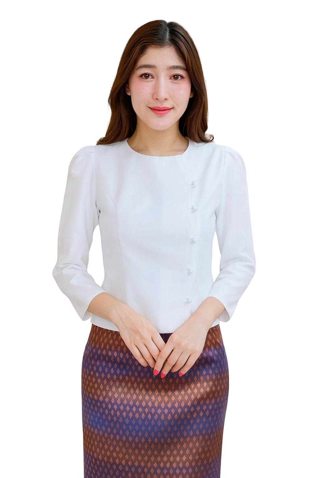 May include: A white long-sleeved blouse with a round neckline and button details. The blouse is paired with a patterned skirt in shades of brown, purple, and blue. The outfit is suitable for formal or semi-formal occasions.