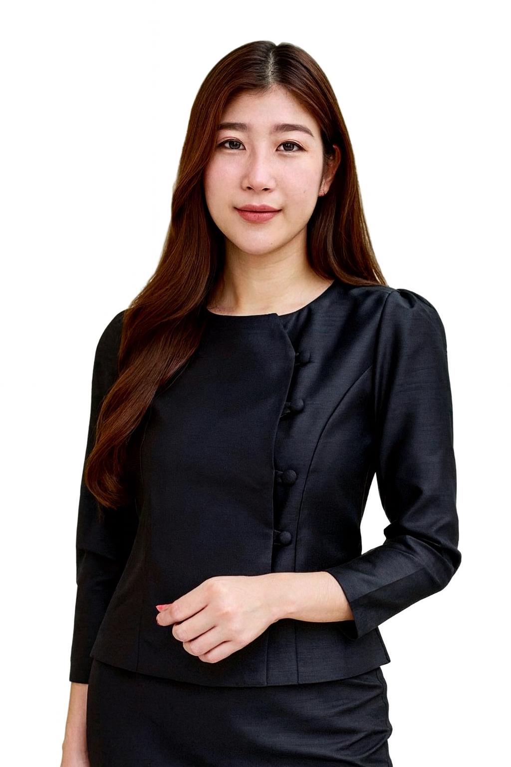May include: Black long-sleeved blouse with a round neckline and button closure. The blouse is part of a two-piece set. The model is wearing the blouse and skirt. The outfit is made of a smooth, dark fabric.