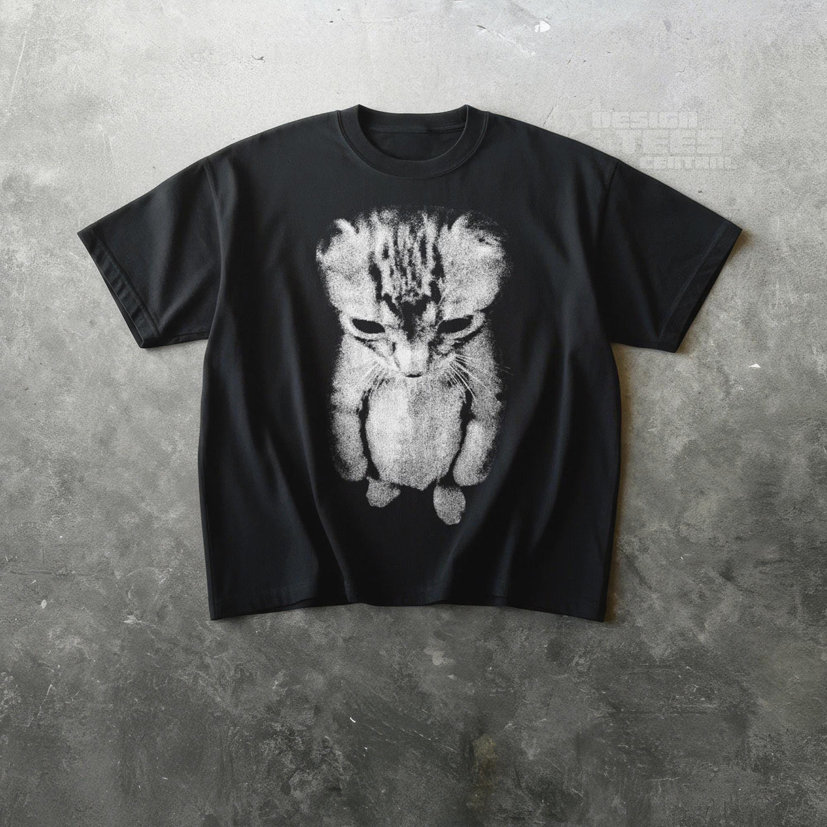 May include: Black t-shirt featuring a distressed, grayscale image of a sad-looking cat. The cat's fur is detailed with stripes and shading, and the design is centered on the shirt. The shirt has short sleeves and a crew neck.
