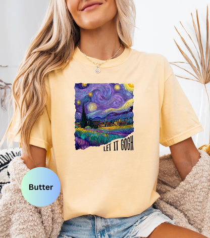 May include: Butter-colored t-shirt featuring a vibrant print of Van Gogh's "Starry Night" painting. The artwork showcases swirling blues, purples, and yellows, with the text "LET IT GOGH" in black. The shirt has short sleeves and a relaxed fit.