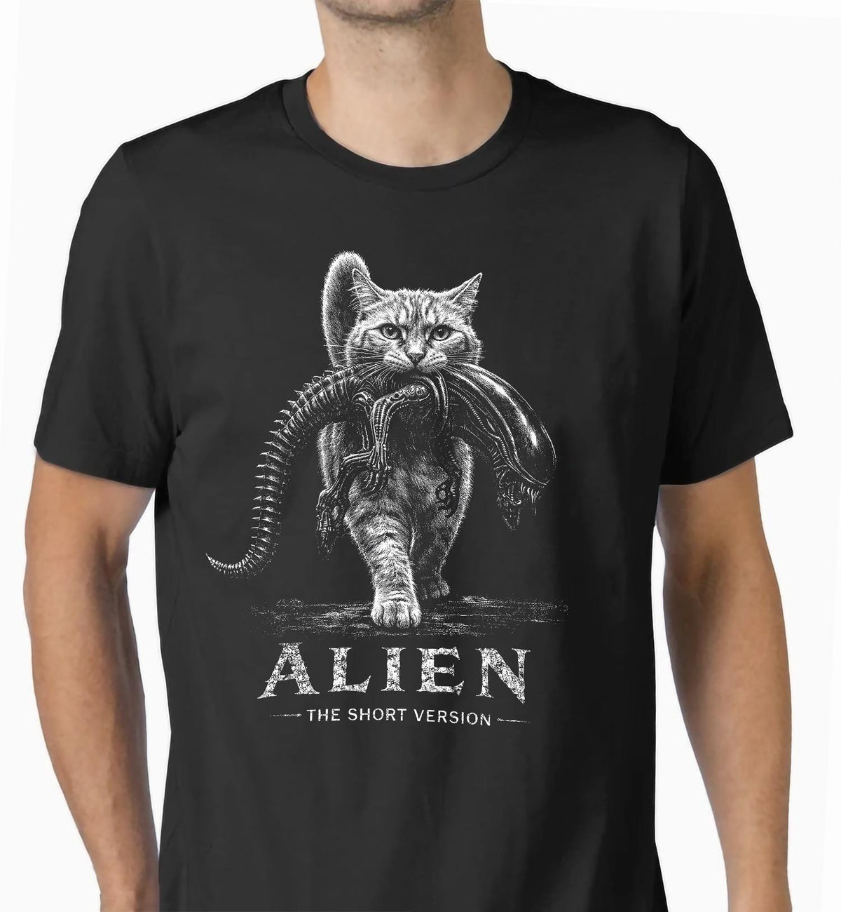 May include: A black short-sleeved t-shirt featuring a white graphic illustration of a cat carrying an alien creature in its mouth. Below the illustration, the text reads ALIEN THE SHORT VERSION in a distressed white font centered on the chest.