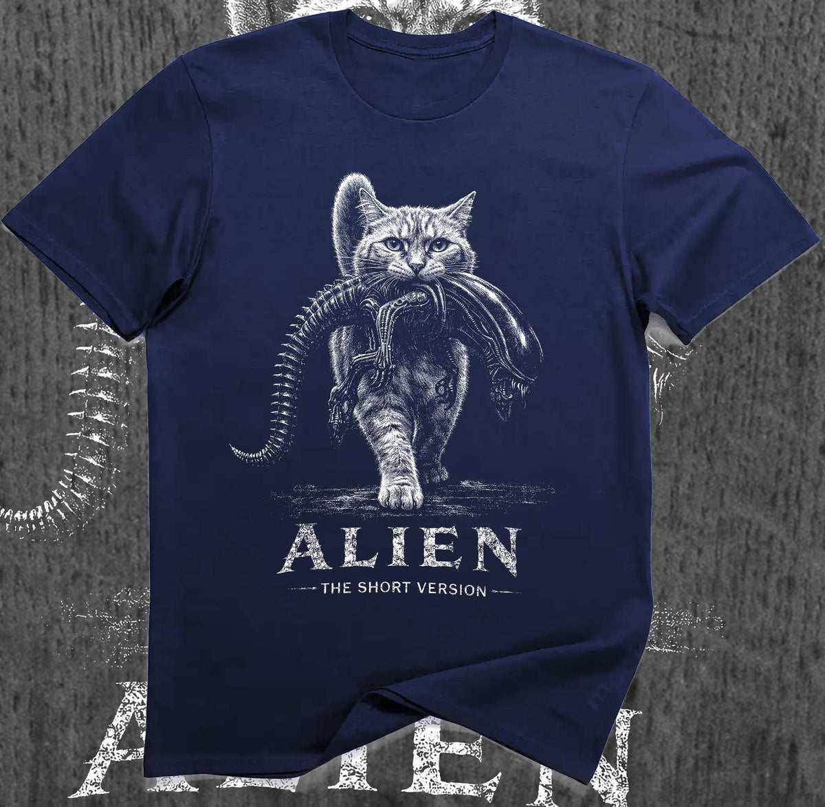 May include: A navy blue short-sleeved t-shirt featuring a white graphic of a cat carrying an alien creature in its mouth. Below the graphic, the text reads ALIEN THE SHORT VERSION in a distressed white font, centered on the chest of the garment.