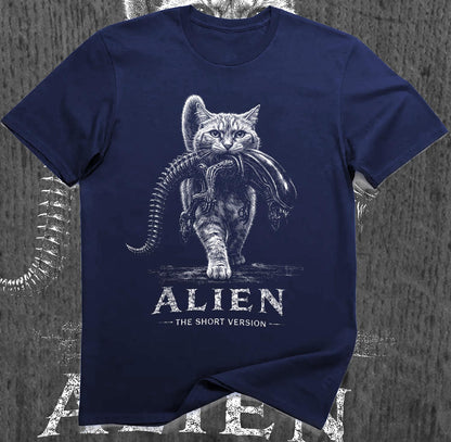 May include: A navy blue short-sleeved t-shirt featuring a white graphic of a cat carrying an alien creature in its mouth. Below the graphic, the text reads ALIEN THE SHORT VERSION in a distressed white font, centered on the chest of the garment.
