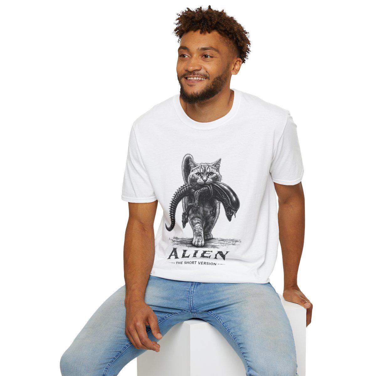 May include: A white short-sleeve t-shirt featuring a black and white graphic of a cat carrying an alien creature in its mouth. Below the graphic, the text reads ALIEN THE SHORT VERSION in a bold, distressed font style on the front of the shirt.