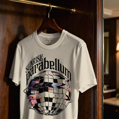 May include: A white short-sleeved t-shirt featuring a black graphic print of a distorted disco ball. Above the disco ball, the text reads "SUNRISE parabellum" in a stylized black font. The shirt is hanging on a wooden hanger.