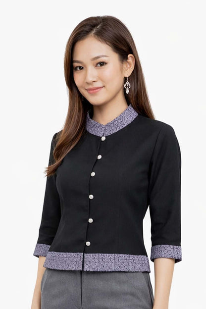 May include: Black button-down blouse with three-quarter sleeves. The blouse features a mandarin collar and cuffs with a patterned design in shades of purple and white. The blouse has a tailored fit and is buttoned up the front.
