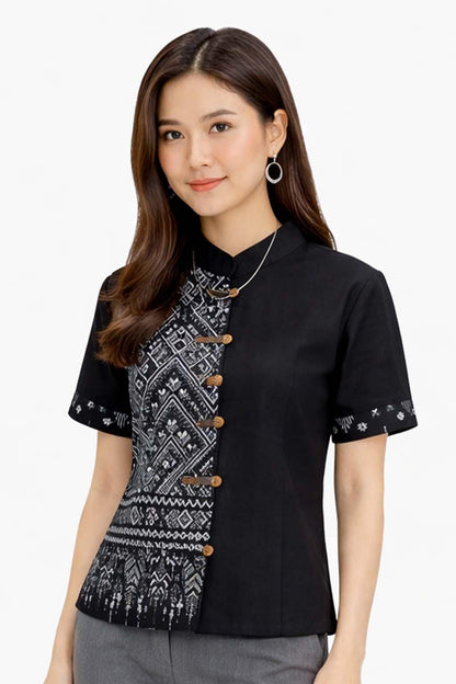 May include: Black short-sleeved shirt with a mandarin collar and decorative wooden buttons. The left side features a black and white geometric pattern. The sleeves have a small patterned border. A silver necklace is visible.