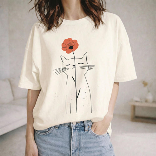 May include: An off-white short-sleeve t-shirt featuring a black line art illustration of a cat with closed eyes. The cat is holding a single orange-red poppy flower on a thin stem that extends vertically between its ears.