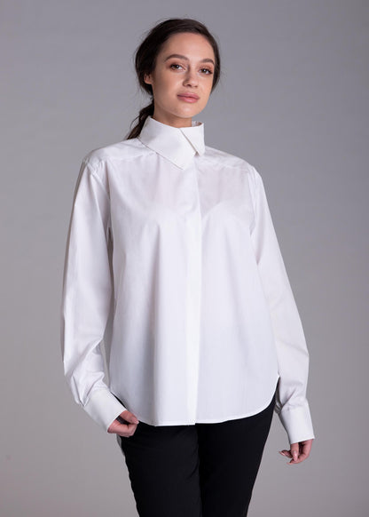 May include: A crisp white long-sleeved button-down shirt featuring a structured high collar, a concealed front placket, and wide cuffs. The shirt is made of a smooth, opaque fabric and is paired with simple black trousers, creating a clean look.