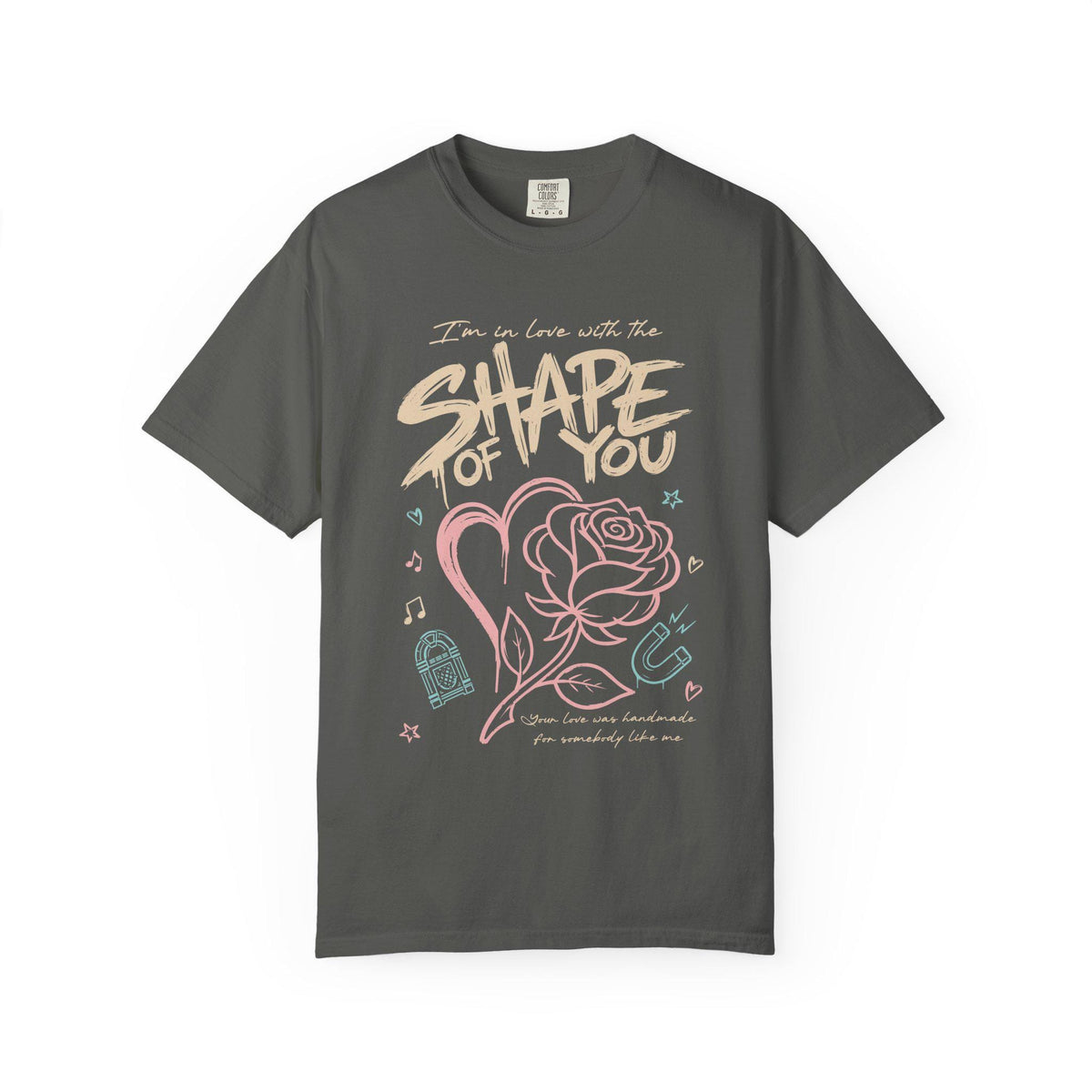 Shape of You” text with heart and rose illustration, music icons and pastel accents printed on a pepper Comfort Colors oversized T-shirt.