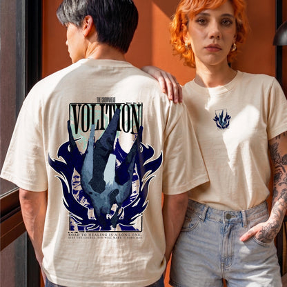 May include: A beige short-sleeve t-shirt featuring a large graphic on the back with the text VOLITION and THE GROWNHEAD. The design includes a dark blue abstract shape and the text ROAD TO HEALING IS A LONG ONE. STAY THE COURSE. YOU WILL MAKE IT SOME DAY.