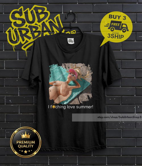 May include: Black t-shirt featuring a graphic of a person in a pink visor and sunglasses, lying on a blue towel. The text "I f*ching love summer!" is printed below the image. The shirt also has the text "BUY 3 FREE" and "PREMIUM QUALITY".