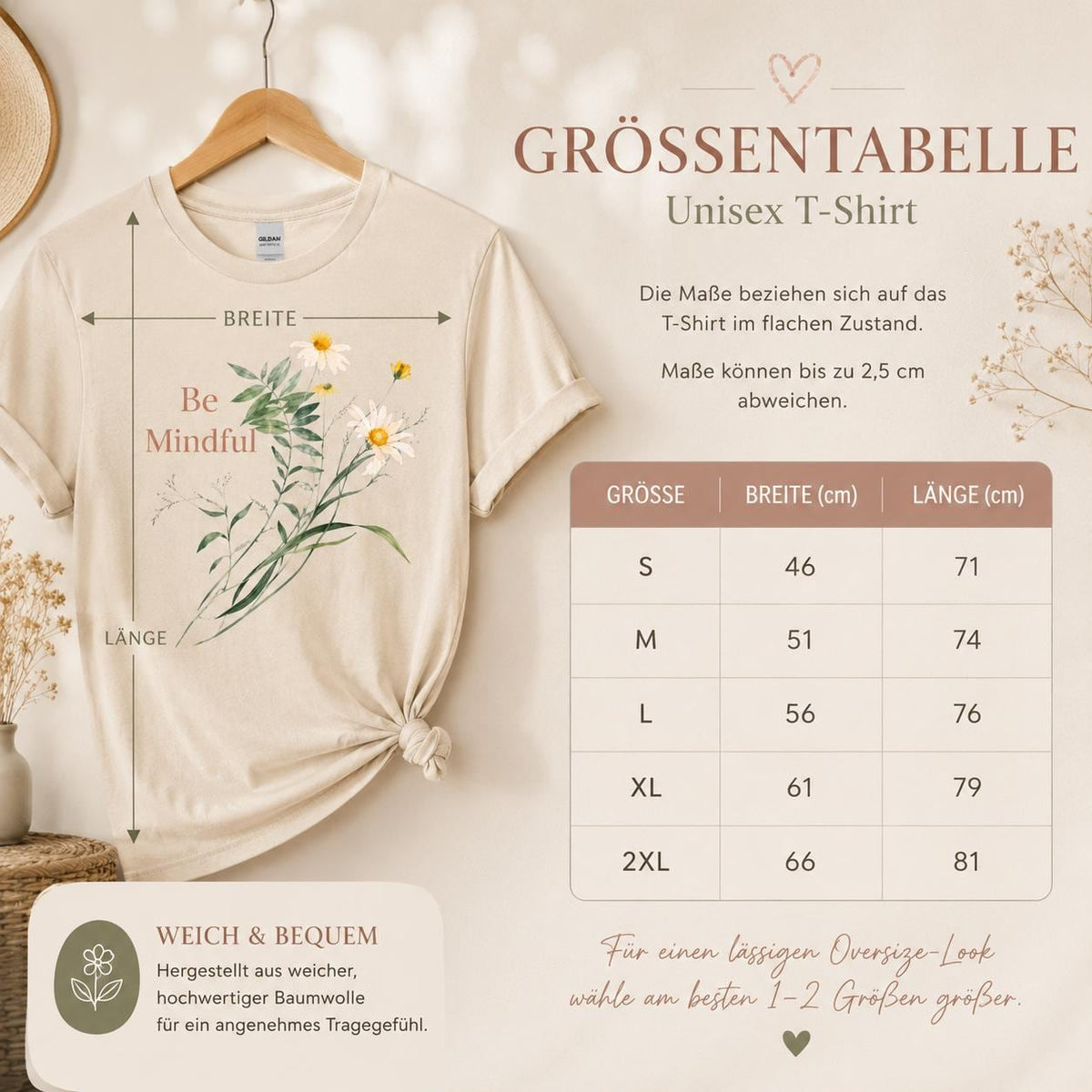 May include: A beige short-sleeved t-shirt featuring a graphic of white daisies and green foliage with the text Be Mindful. A size chart displays measurements in centimeters for sizes S through 2XL, indicating widths from 46 to 66 cm and lengths from 71 to 81 cm.