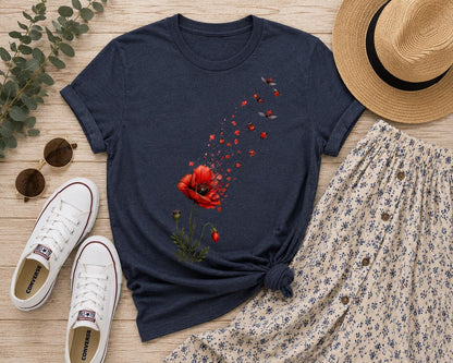 May include: A dark navy blue short-sleeve t-shirt featuring a graphic print of a red poppy flower that appears to be disintegrating into small red petals and flying ladybugs. The shirt has a crew neckline and a straight hemline.
