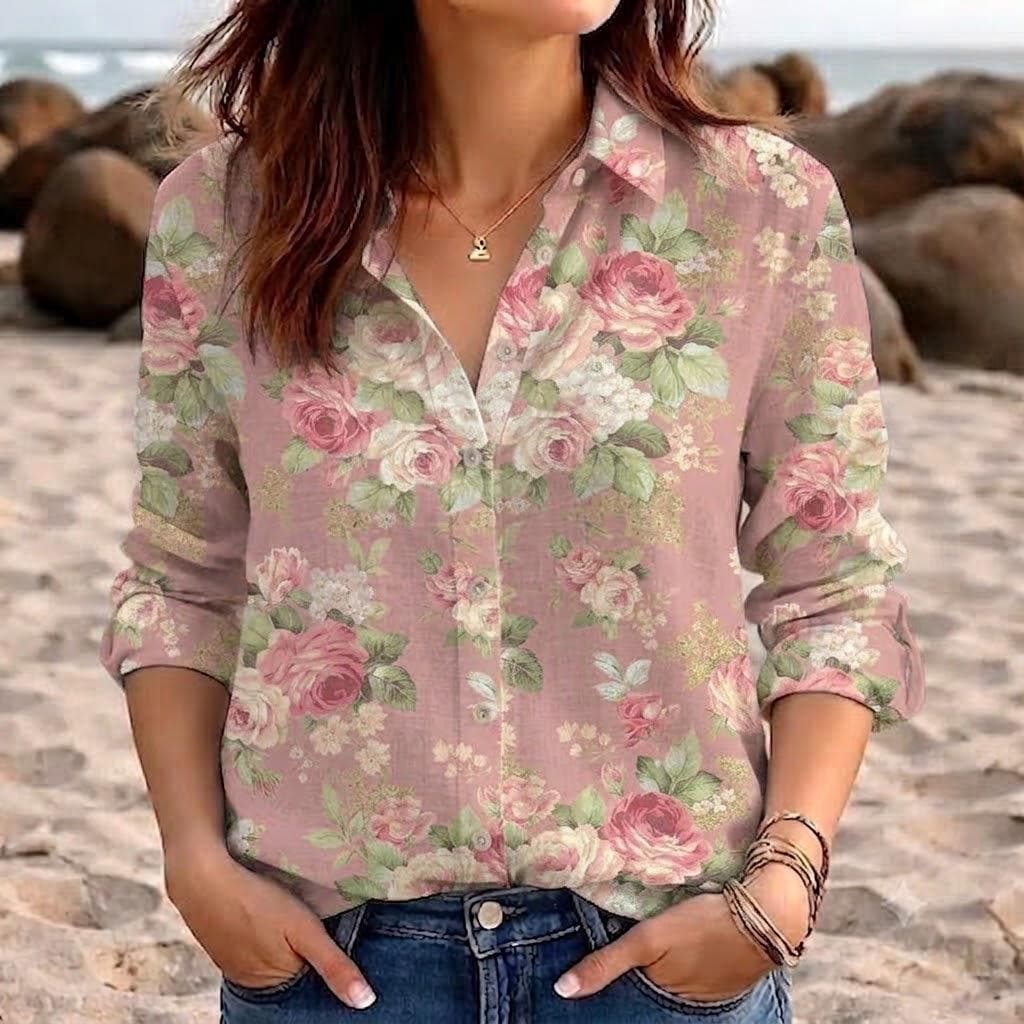 May include: A long-sleeved button-down shirt in a dusty pink hue featuring a repeating floral pattern of pink roses, white blossoms, and green leaves. The shirt has a classic collar, a front button placket, and is paired with blue denim jeans.