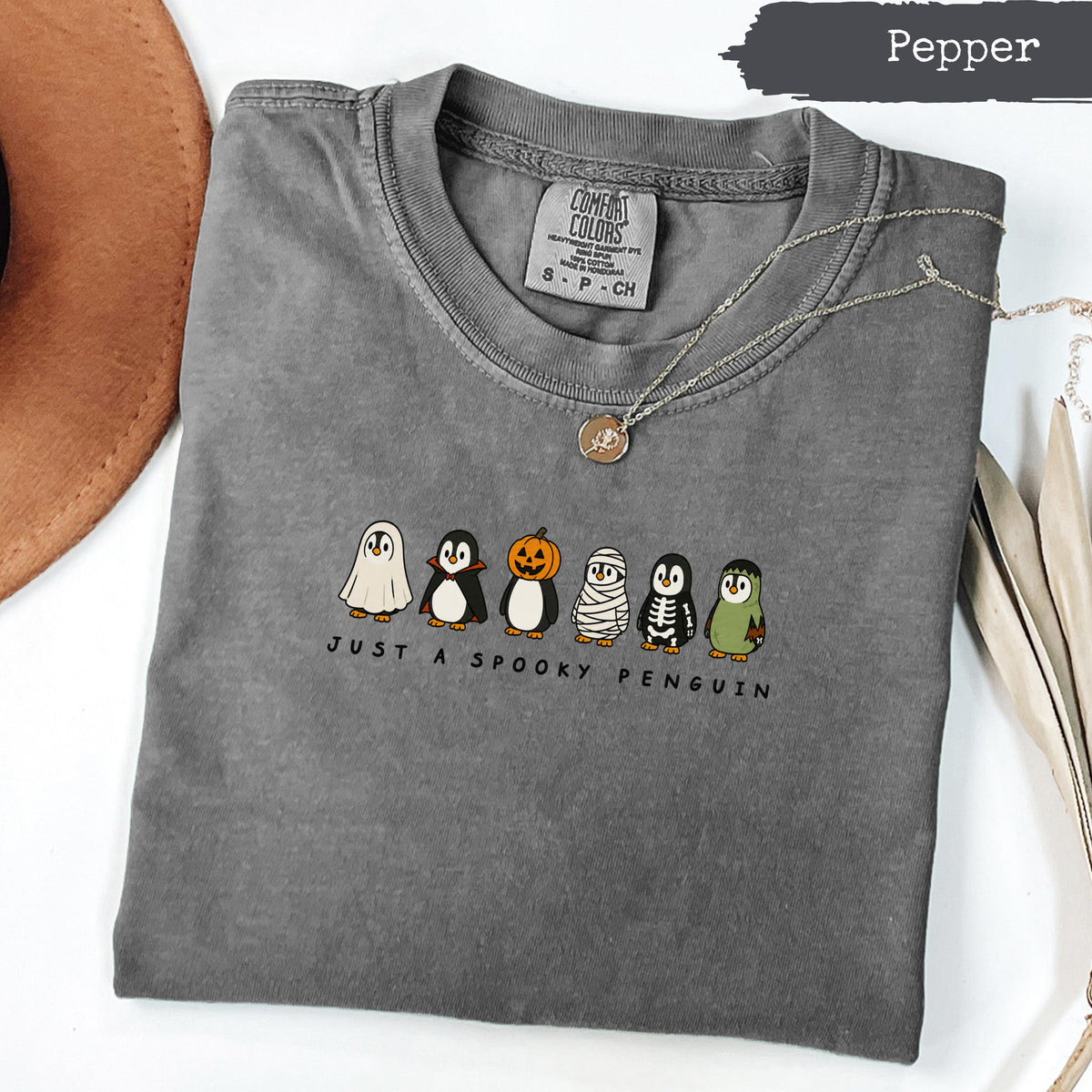 Gray t-shirt with "Just A Spooky Penguin" and Halloween-costumed penguins.