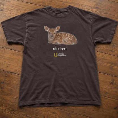 May include: A dark brown short-sleeved t-shirt featuring a graphic of a spotted fawn lying down. Below the fawn, the text reads "oh deer!" in white, followed by the yellow and white National Geographic logo centered on the chest area.