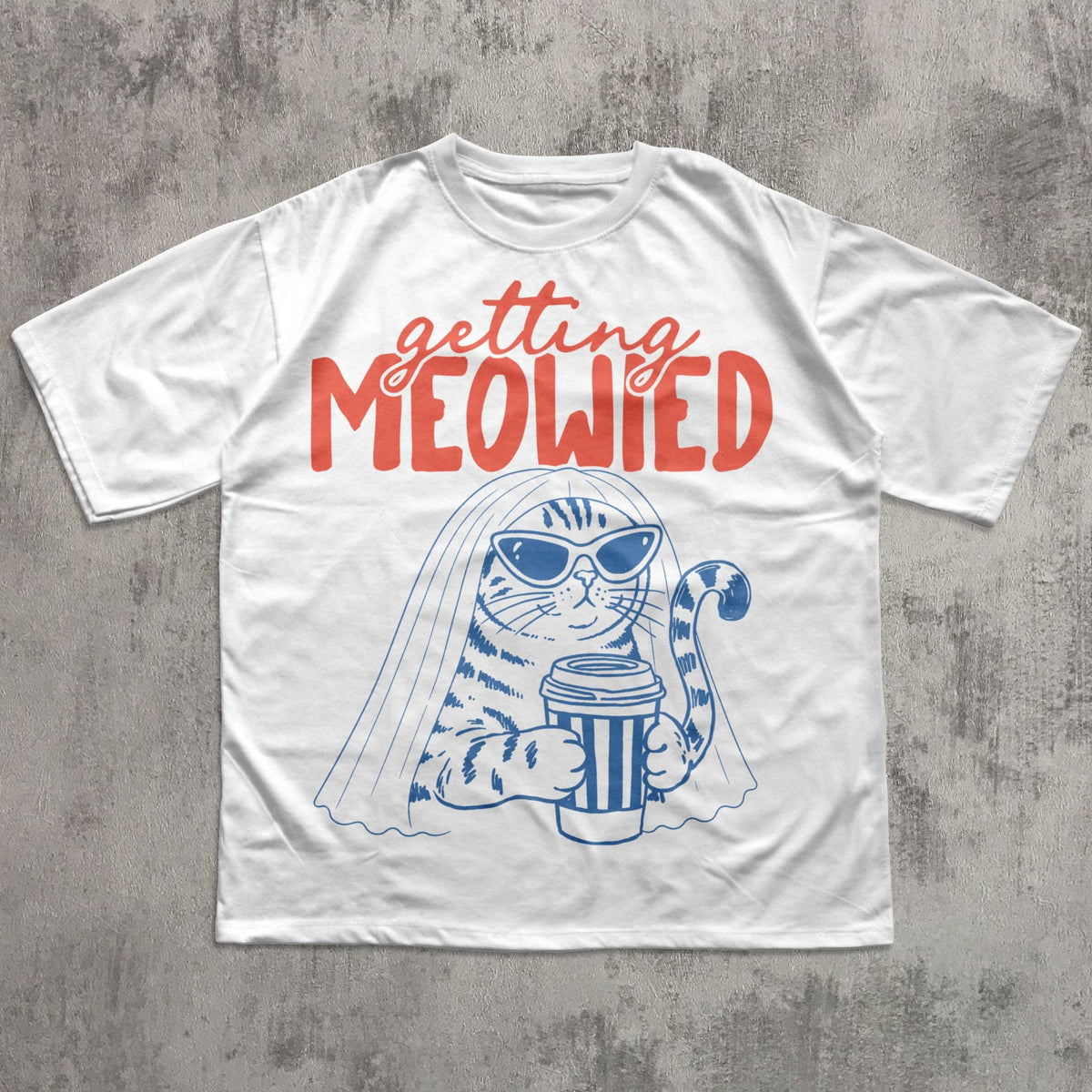 May include: A white t-shirt featuring a graphic of a cat wearing sunglasses and a bridal veil while holding a coffee cup. The text "getting MEOWIED" is printed in red above the cat illustration, which is rendered in blue ink lines.