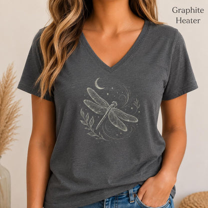 May include: A graphite heather V-neck t-shirt featuring a white line art graphic of a dragonfly, a crescent moon, and small stars. The text Graphite Heater is printed in the upper right corner of the image above the short-sleeved shirt.