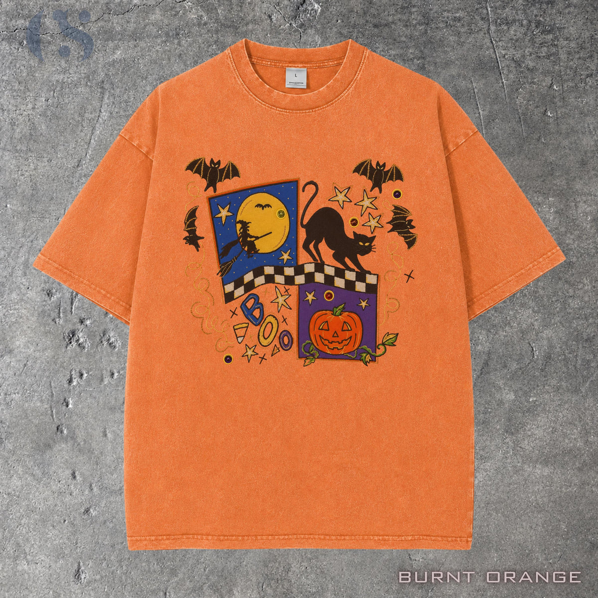 May include: A burnt orange short-sleeve t-shirt featuring a graphic print of a black cat, a jack-o'-lantern, a witch on a broomstick, bats, stars, and the word BOO. The design includes a checkered pattern and various small decorative symbols.