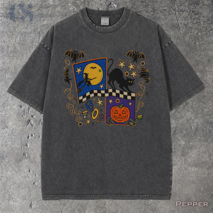 May include: A charcoal gray short-sleeve t-shirt featuring a graphic print with a yellow moon, a black cat, a witch on a broomstick, a jack-o'-lantern, bats, stars, and a checkered pattern. The word BOO is printed in blue letters on the front.