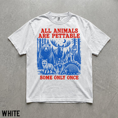 May include: A white short-sleeve t-shirt featuring a blue graphic of a bear, moose, wolf, fox, raccoon, and porcupine in a forest. The red text above reads ALL ANIMALS ARE PETTABLE and the red text below reads SOME ONLY ONCE.