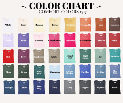 May include: A color chart for Comfort Colors 1717 t-shirts, displaying forty-eight fabric swatches in a grid. Each swatch is labeled with its specific color name, ranging from white, ivory, and yellow tones to reds, greens, blues, and dark neutrals.
