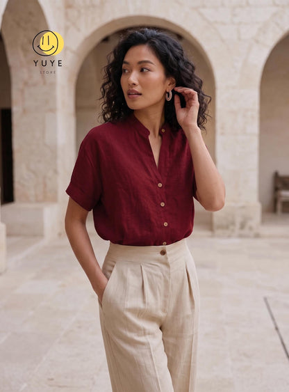 May include: A short-sleeved, button-down shirt in a deep burgundy color with a mandarin collar, paired with high-waisted, beige trousers featuring front pleats. The shirt has a visible button placket and cuffed sleeves. The YUYE STORE logo is visible.